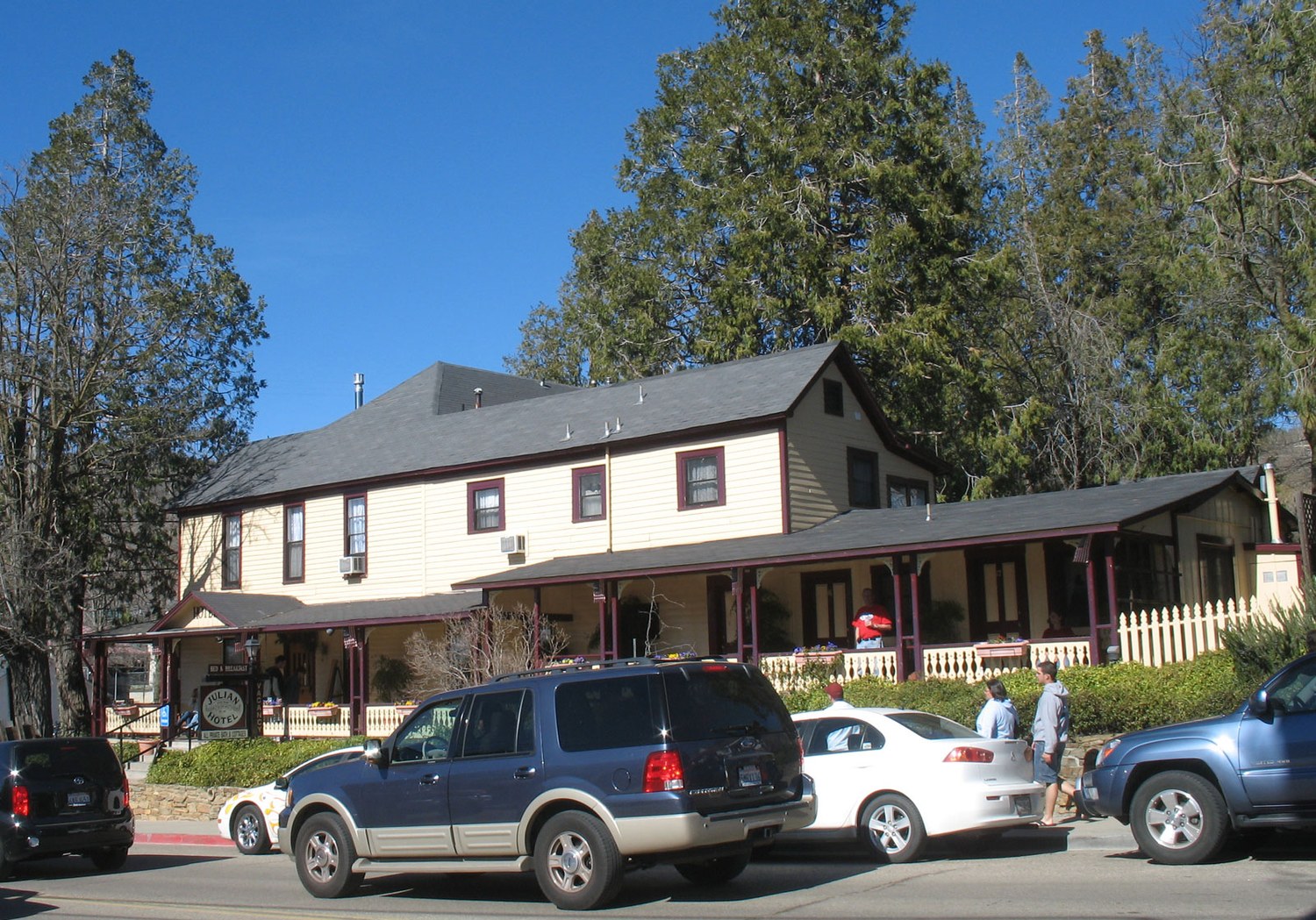 The Julian Hotel on Main Street in Julian, California, photographed in 2008, a two story cream coloured frame building with a covered porch and cars parked along the street in front