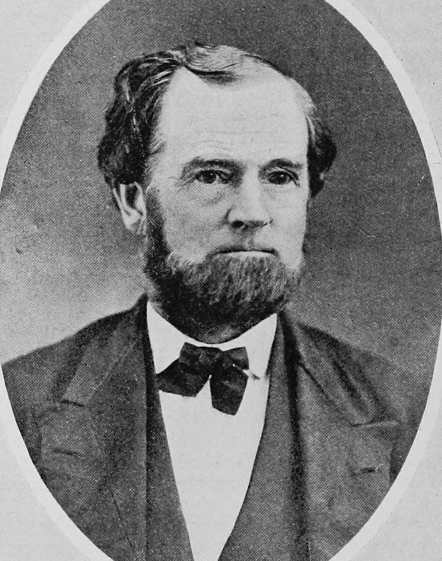Oval portrait of a bearded man with a bow tie and dark jacket