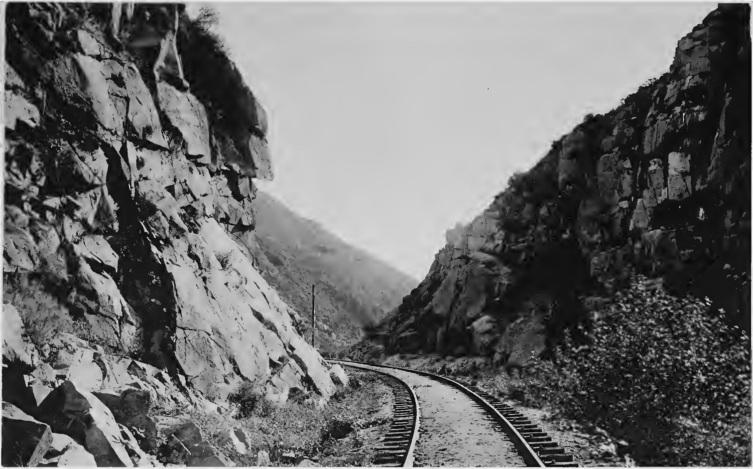 A single railroad track running between sheer rock walls in the narrowest part of Temecula Canyon, photographed in 1887