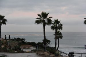Fletcher Cove in Solana Beach photographed in 2013, the park at the top of the cut in the bluff with palms, steps and railings leading down through the gap to the sand and the ocean beyond
