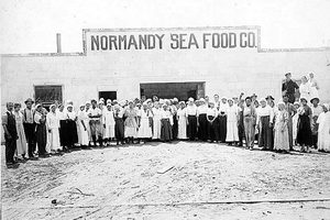 Workers standing outside the Normandy Sea Food Company processing building in San Diego, California, around 1918
